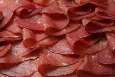 Slices of tasty bresaola as background, closeup