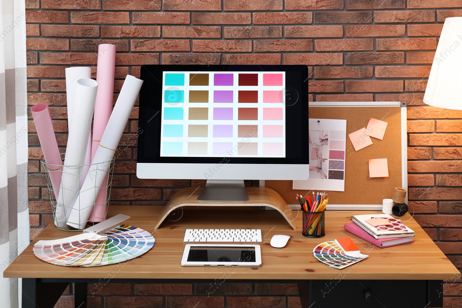 Photo of Modern computer and office supplies on wooden table. Designer's workplace