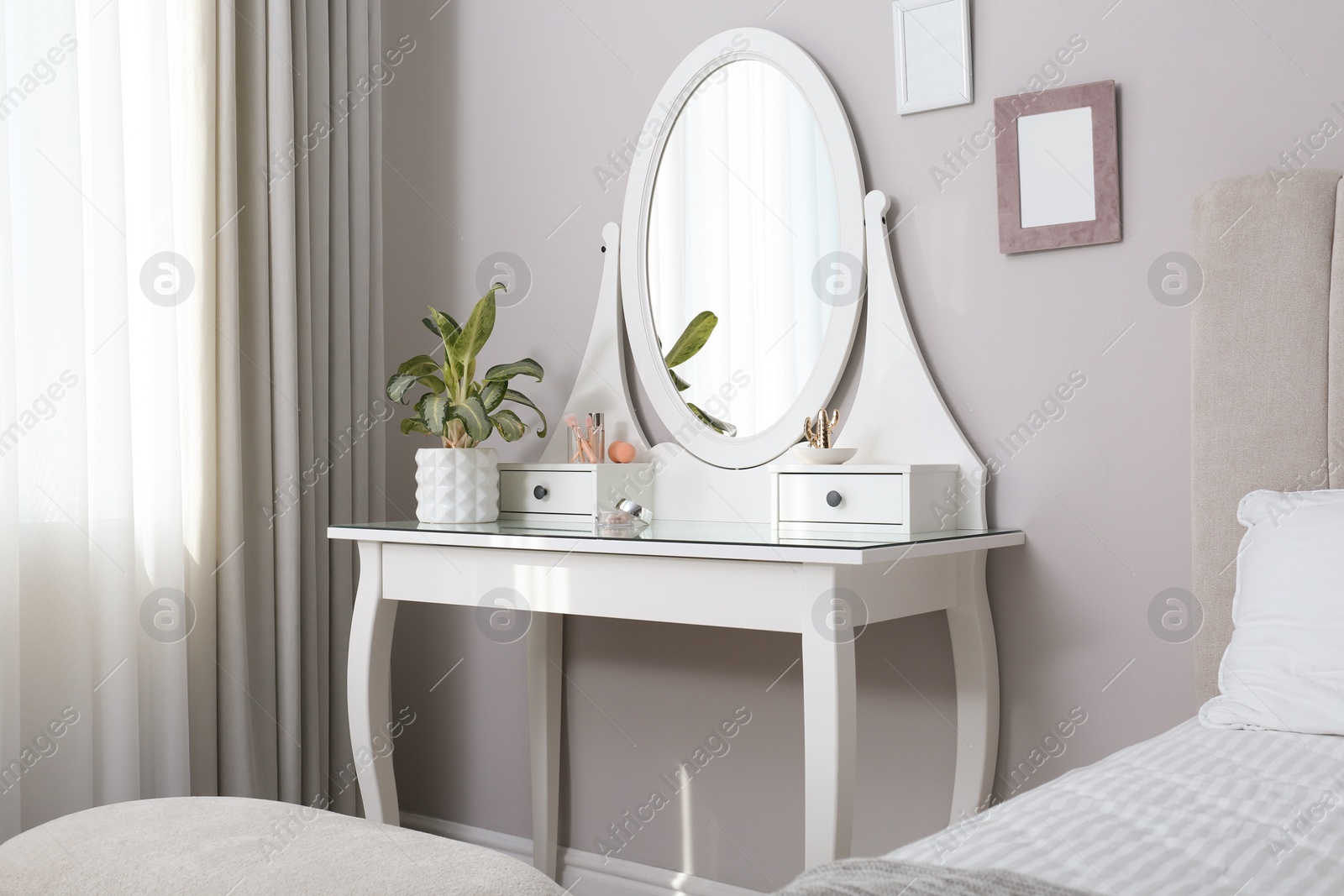 Photo of Elegant dressing table with mirror near window in bedroom