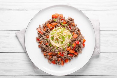 Tasty minced meat with spaghetti, vegetables and green onion on white wooden table, top view