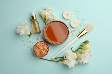 Photo of Flat lay composition with cosmetic product for spa body wraps on light blue background