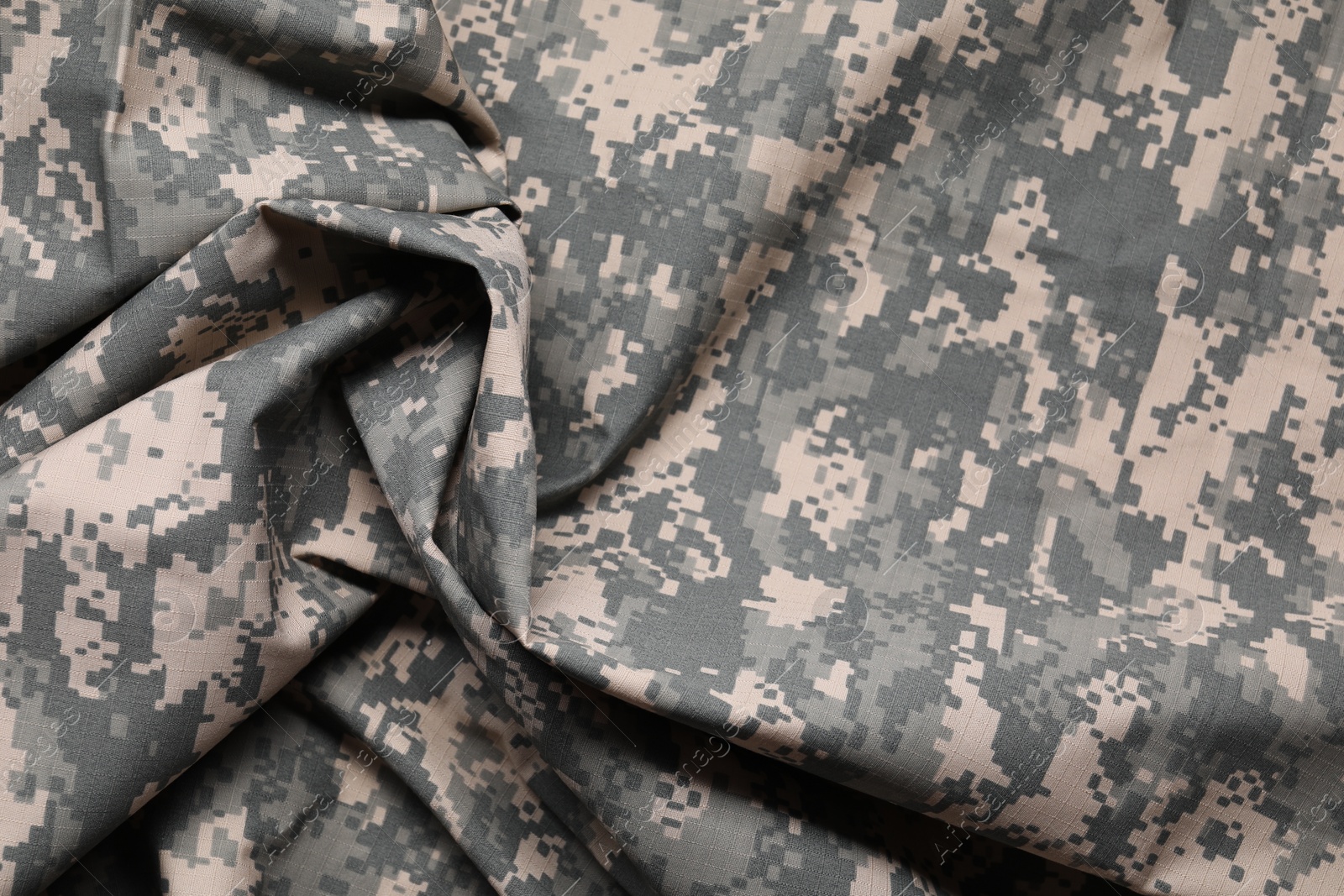 Photo of Texture of crumpled camouflage fabric as background, top view