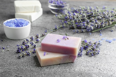 Hand made soap bars with lavender flowers on grey stone table