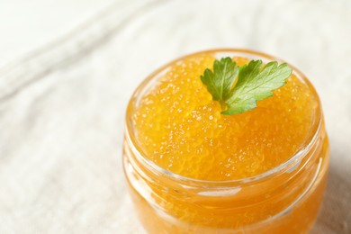 Fresh pike caviar in glass jar on table, closeup