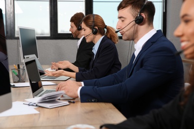 Team of technical support with headsets at workplace