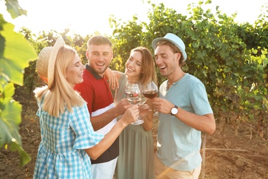 Photo of Friends drinking wine and having fun at vineyard