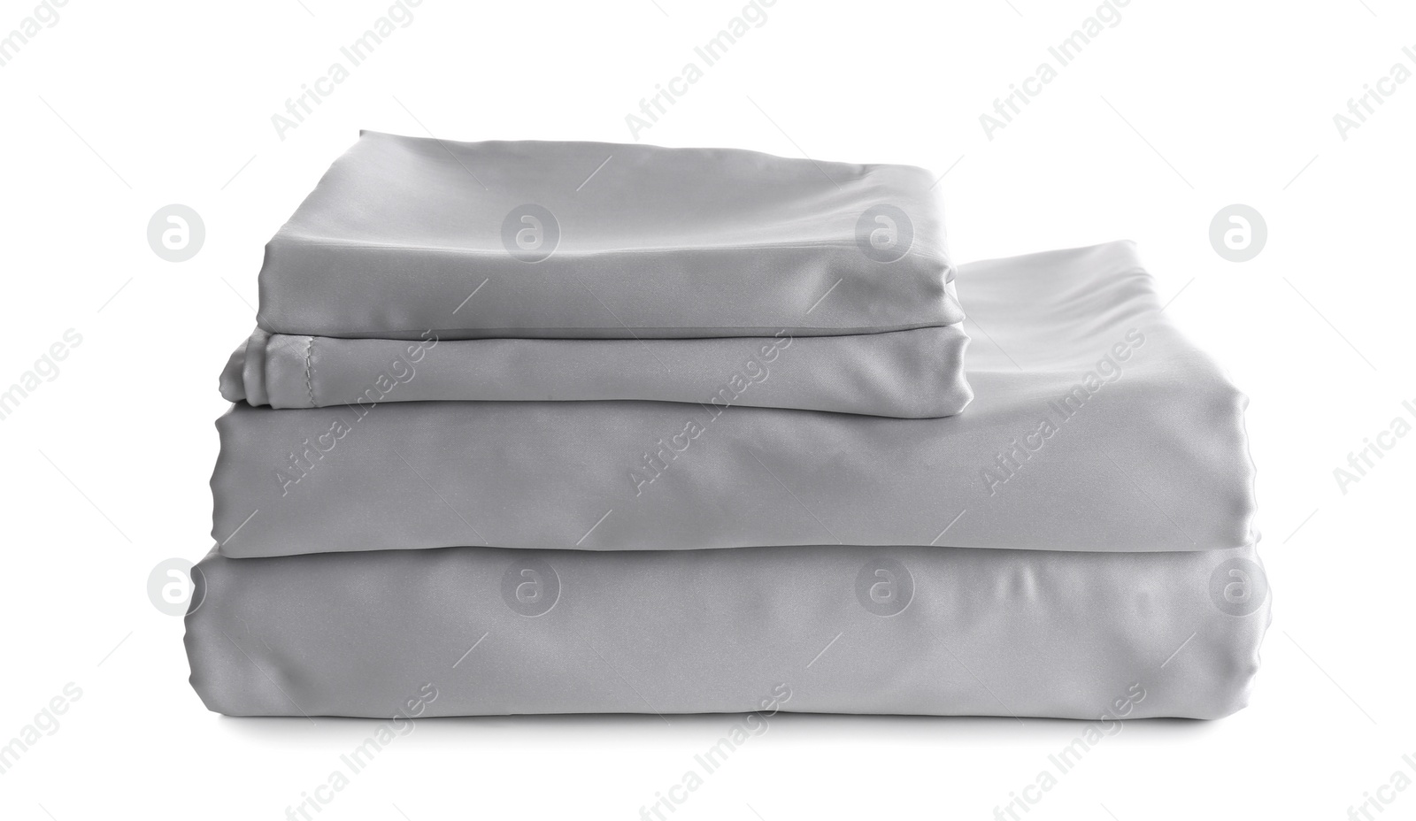 Photo of Stack of clean silky bed linen isolated on white