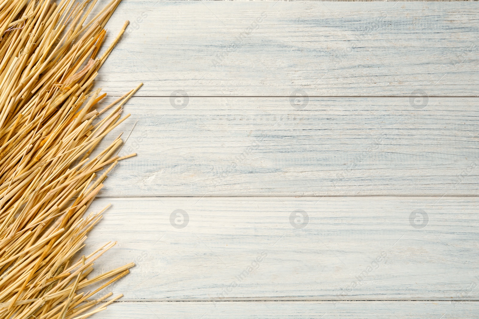 Photo of Dried hay on white wooden background, flat lay. Space for text