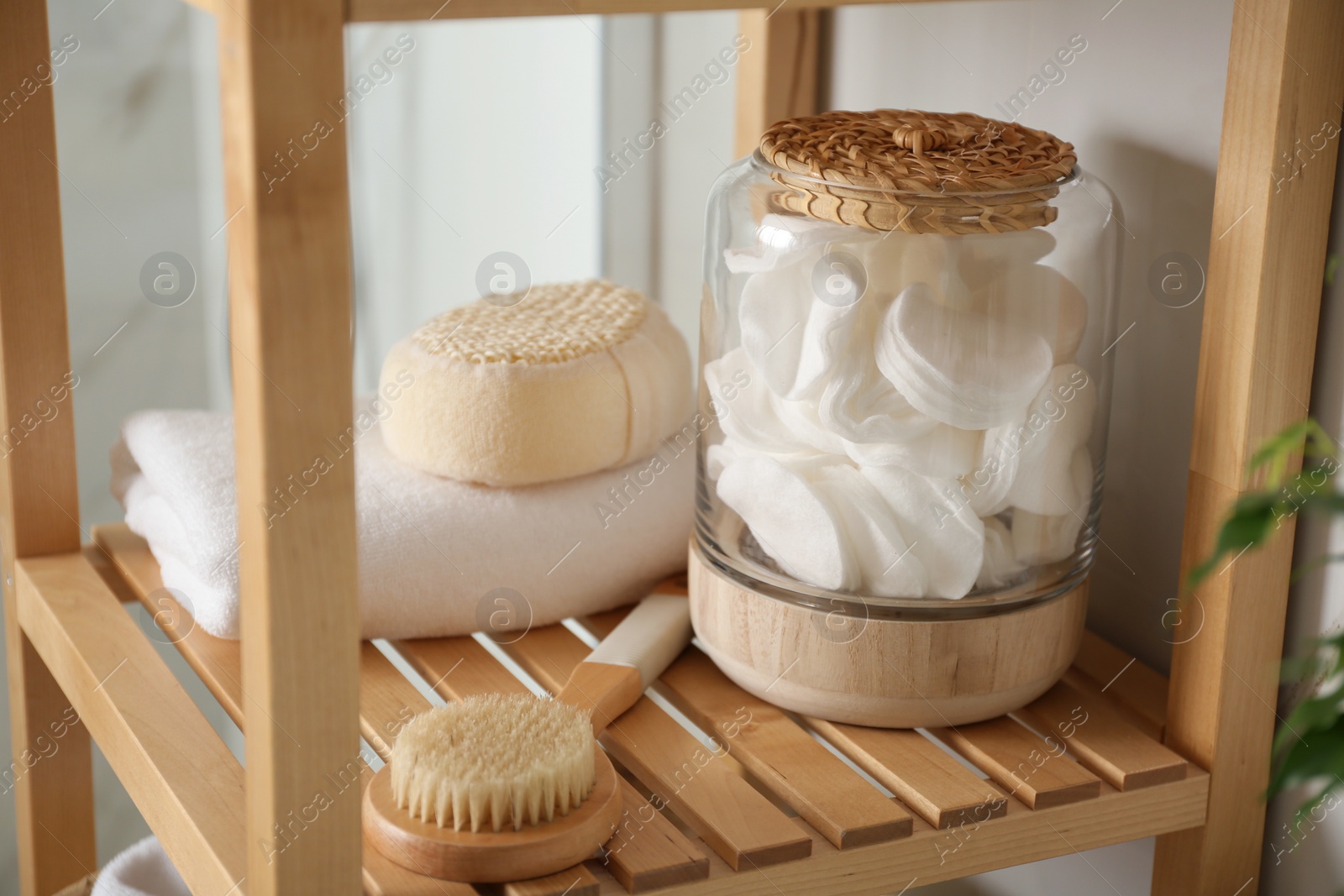 Photo of Shelving unit with toiletries in bathroom interior