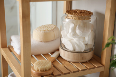 Shelving unit with toiletries in bathroom interior