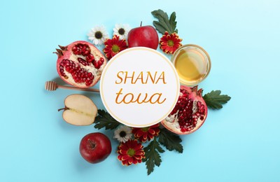 Flat lay composition with Rosh Hashanah holiday attributes and card on light blue background 