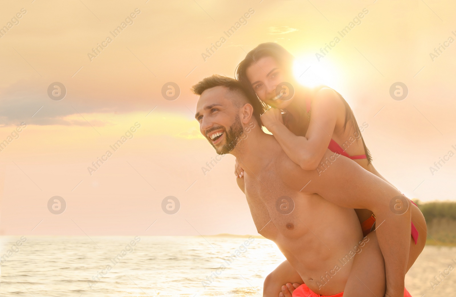 Photo of Happy young couple having fun on beach on sunny day