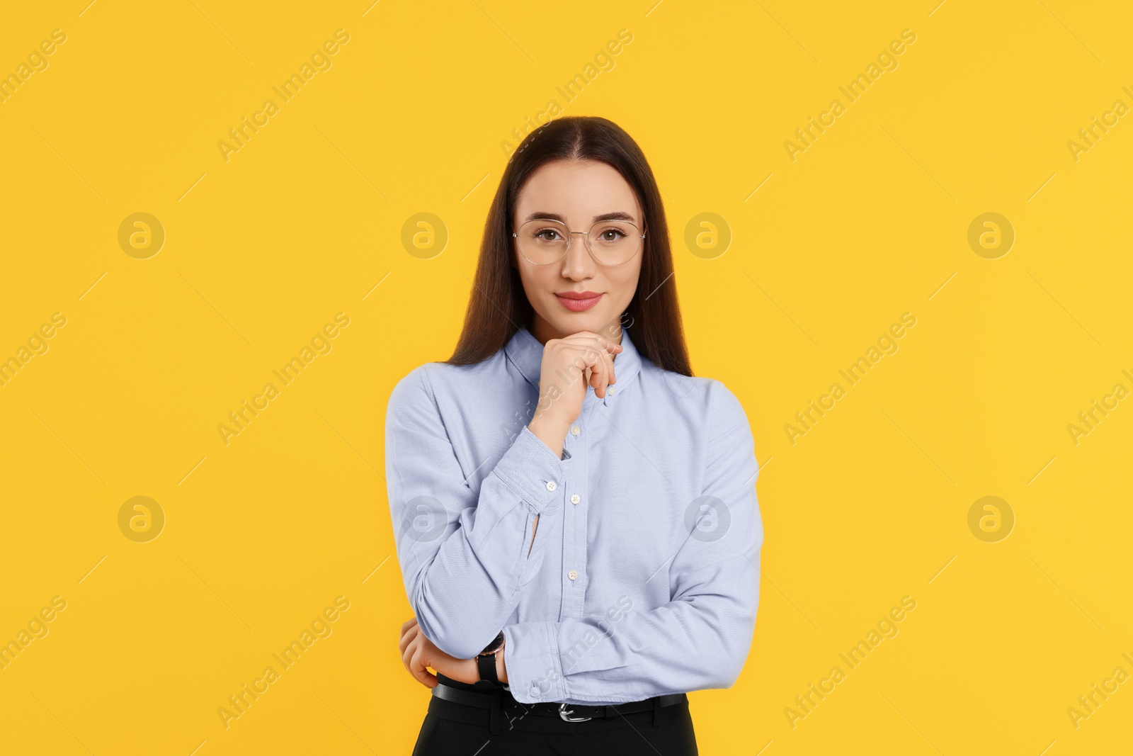 Photo of Beautiful woman wearing glasses on orange background