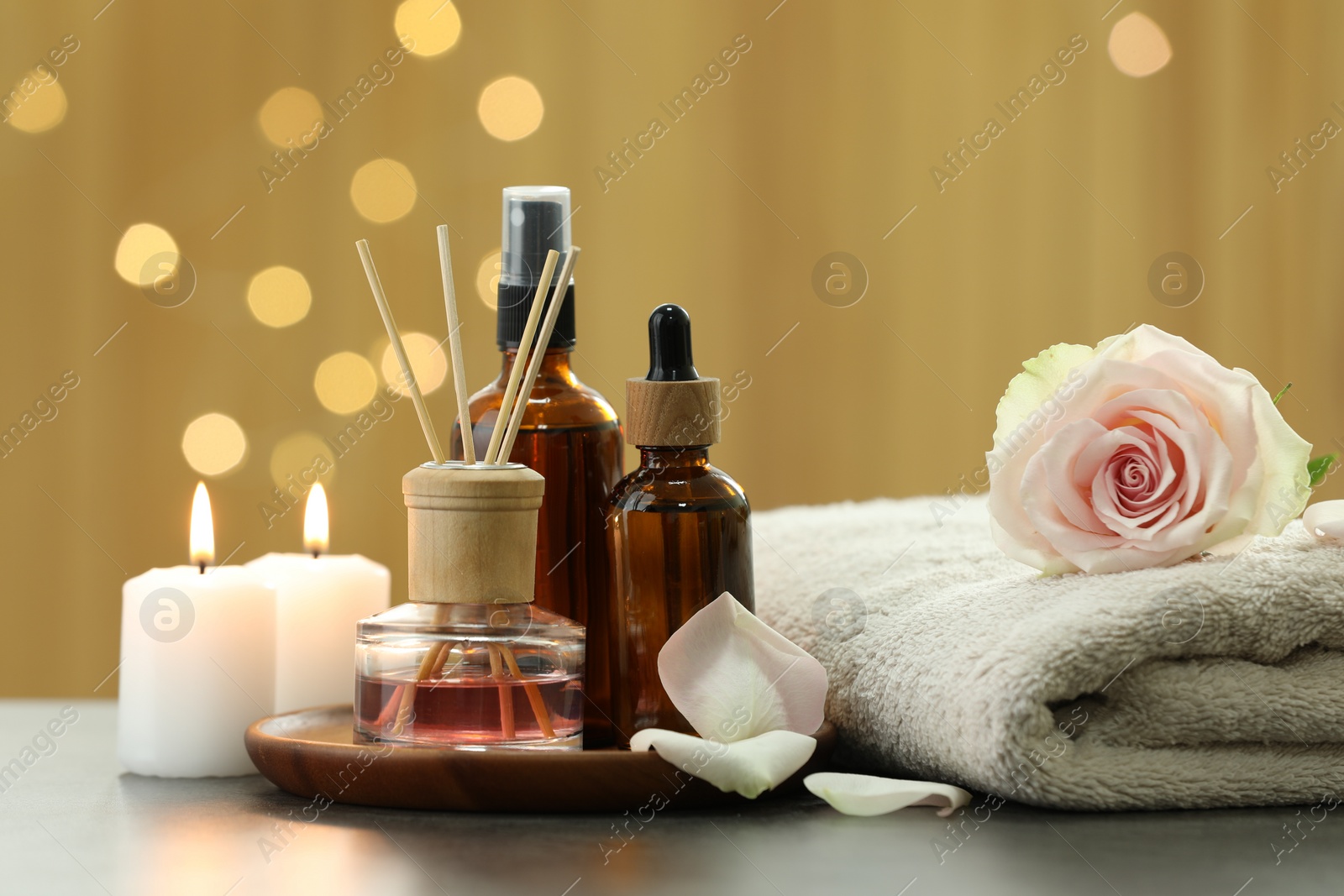 Photo of Composition with different spa products and rose flower on light table