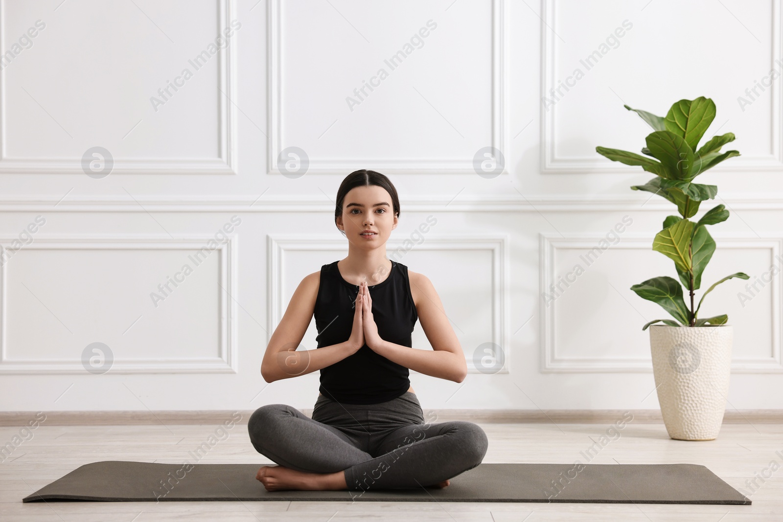 Photo of Beautiful girl meditating on mat in yoga studio