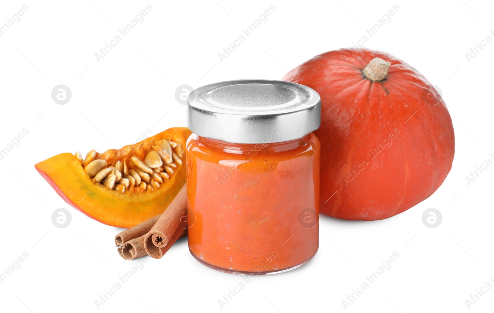 Photo of Jar of pumpkin jam, fresh pumpkin and cinnamon on white background