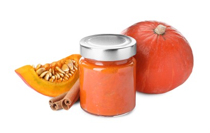Photo of Jar of pumpkin jam, fresh pumpkin and cinnamon on white background