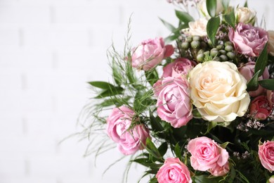 Photo of Beautiful bouquet with roses on white background, closeup. Space for text