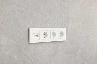 Photo of Wall with power outlet sockets in room. Interior design