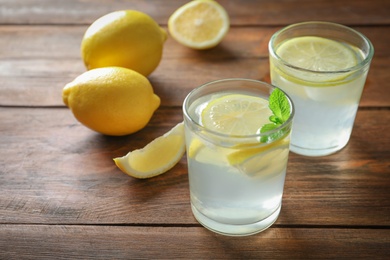 Photo of Natural lemonade with mint in glasses on wooden table