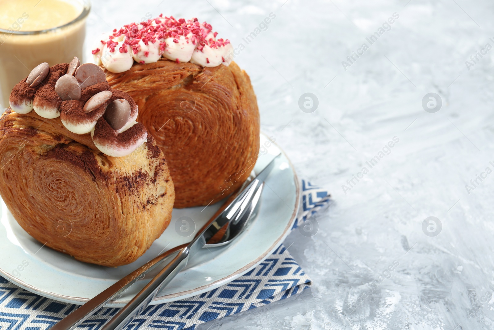 Photo of Crunchy round croissants served on light textured table, space for text. Tasty puff pastry