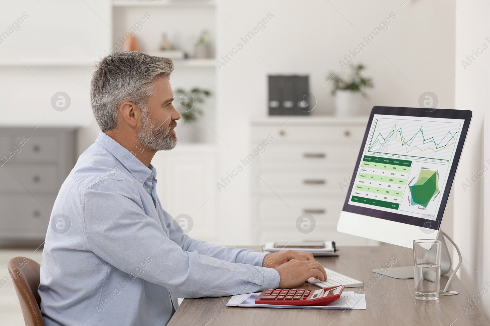 Photo of Professional accountant working at wooden desk in office