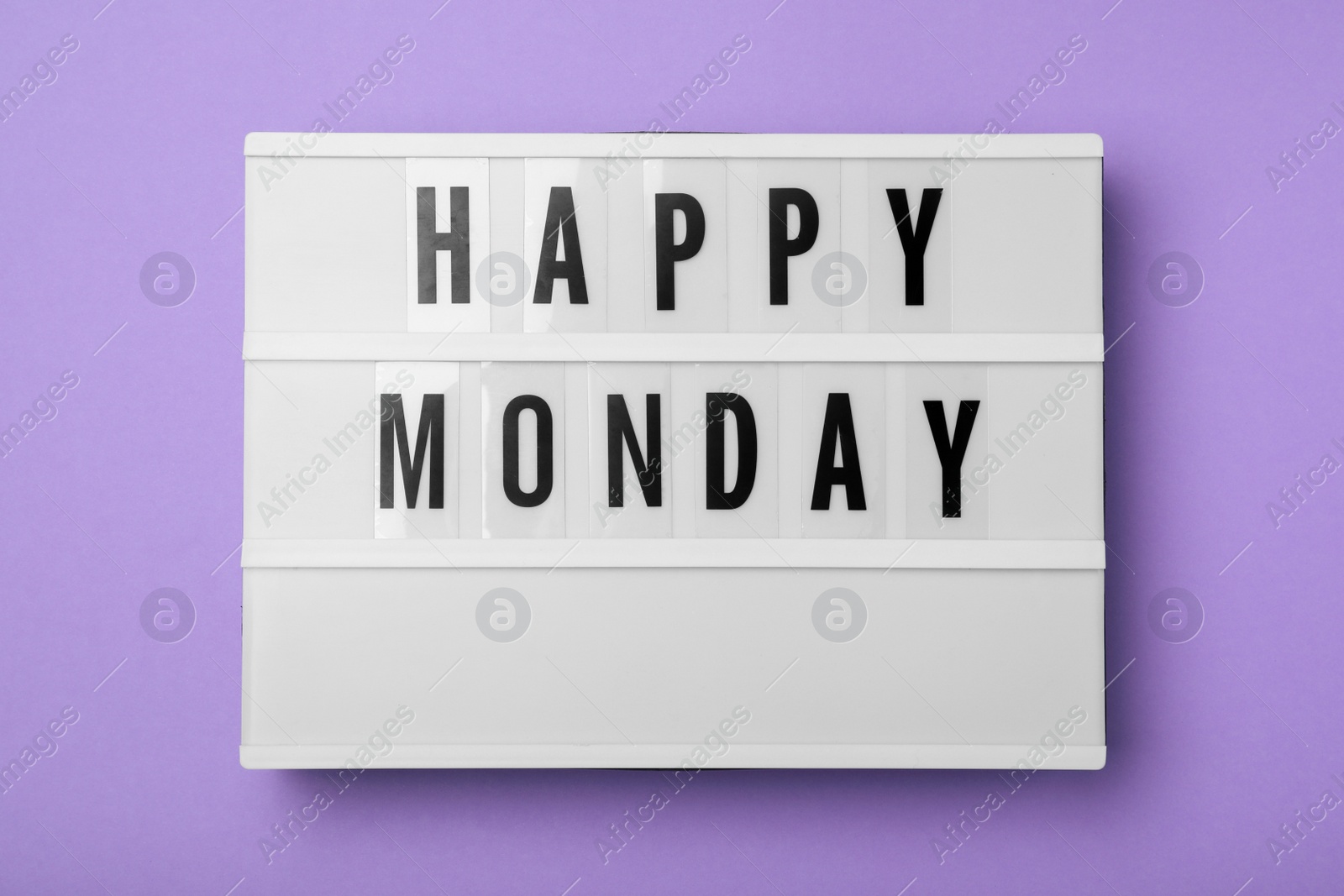 Photo of Light box with message Happy Monday on lilac background, top view