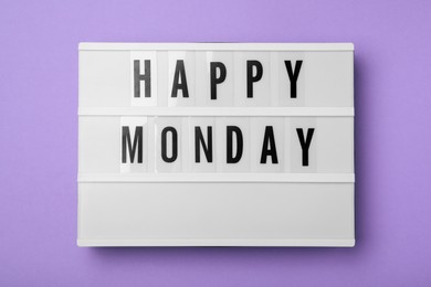 Photo of Light box with message Happy Monday on lilac background, top view