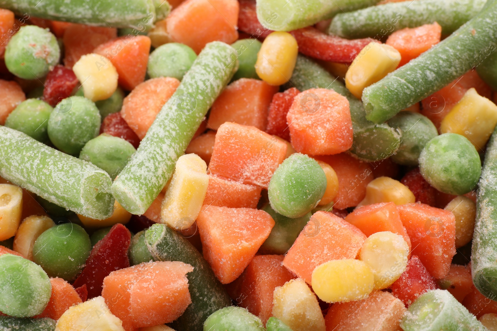 Photo of Mix of different frozen vegetables as background, closeup