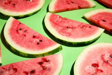 Photo of Slices of ripe watermelon on green background, closeup