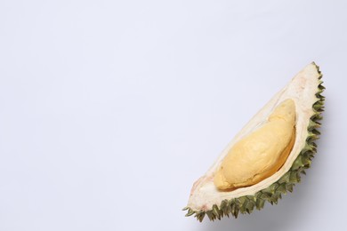Photo of Piece of fresh ripe durian on white background, top view. Space for text