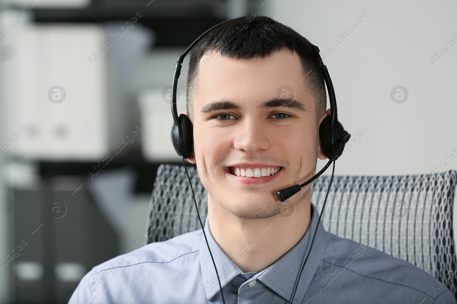 Photo of Hotline operator with headset working in office