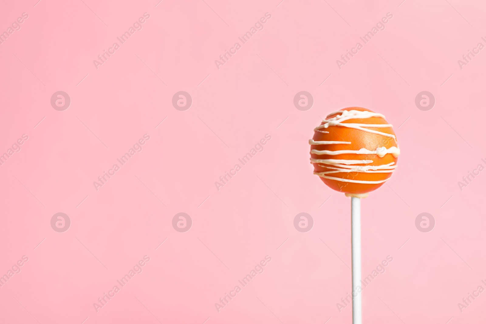 Photo of Bright delicious cake pop on color background. Space for text