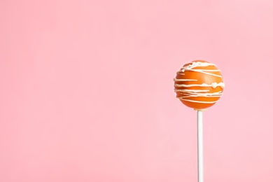 Bright delicious cake pop on color background. Space for text