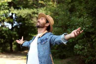 Photo of Feeling freedom. Smiling man enjoying nature outdoors