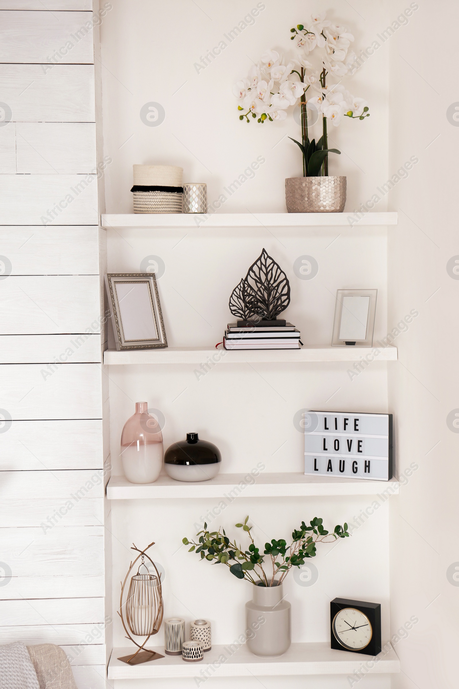 Photo of Wall shelves with beautiful decor elements indoors. Interior design