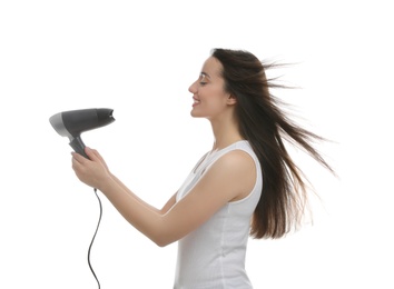 Photo of Beautiful young woman using hair dryer on white background