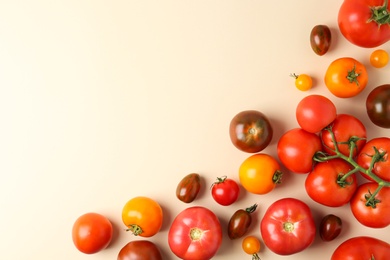 Photo of Flat lay composition with fresh ripe tomatoes on beige background. Space for text