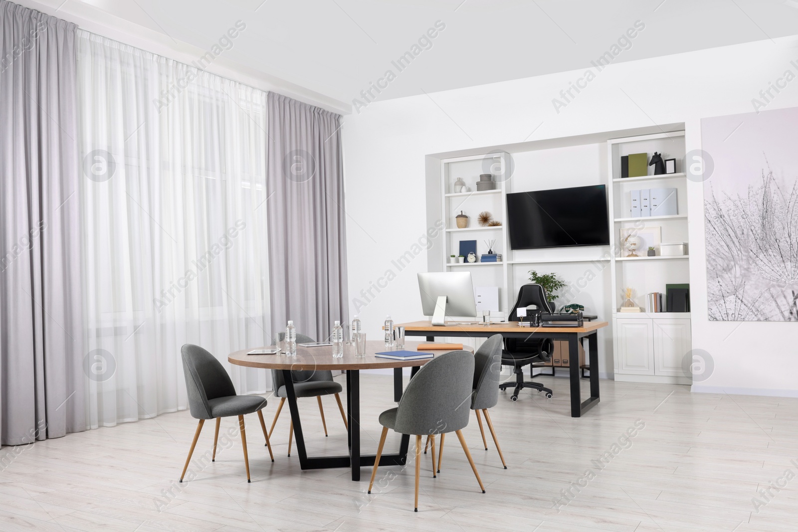 Photo of Stylish office with comfortable furniture and tv zone. Interior design