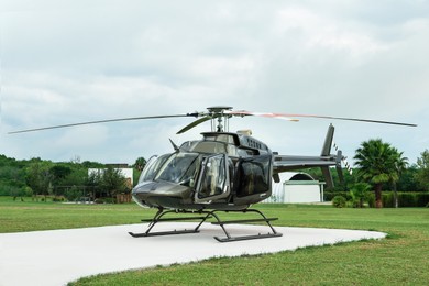 Beautiful modern helicopter on helipad in field