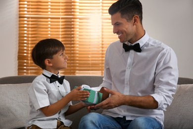 Photo of Man receiving gift for Father's Day from his son at home
