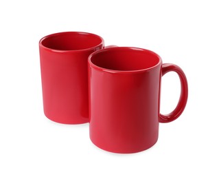 Photo of Two red ceramic mugs isolated on white