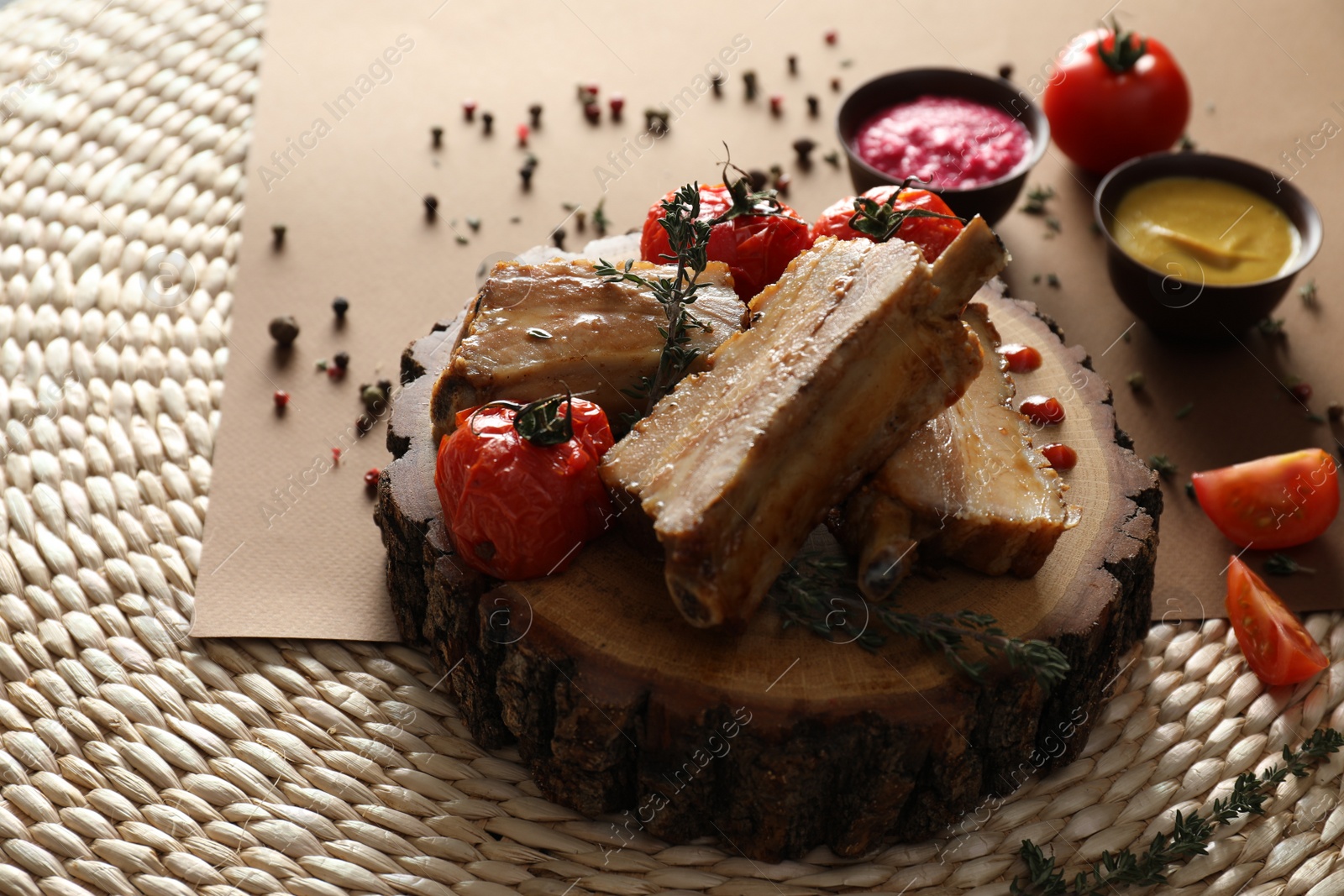 Photo of Delicious roasted ribs with tomatoes served on table