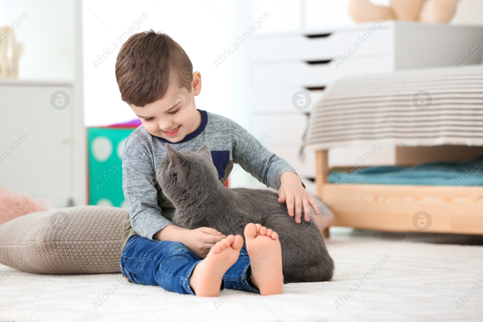 Photo of Cute little child with cat at home