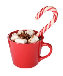 Photo of Cup of hot chocolate with marshmallows, Christmas candy cane and anise isolated on white