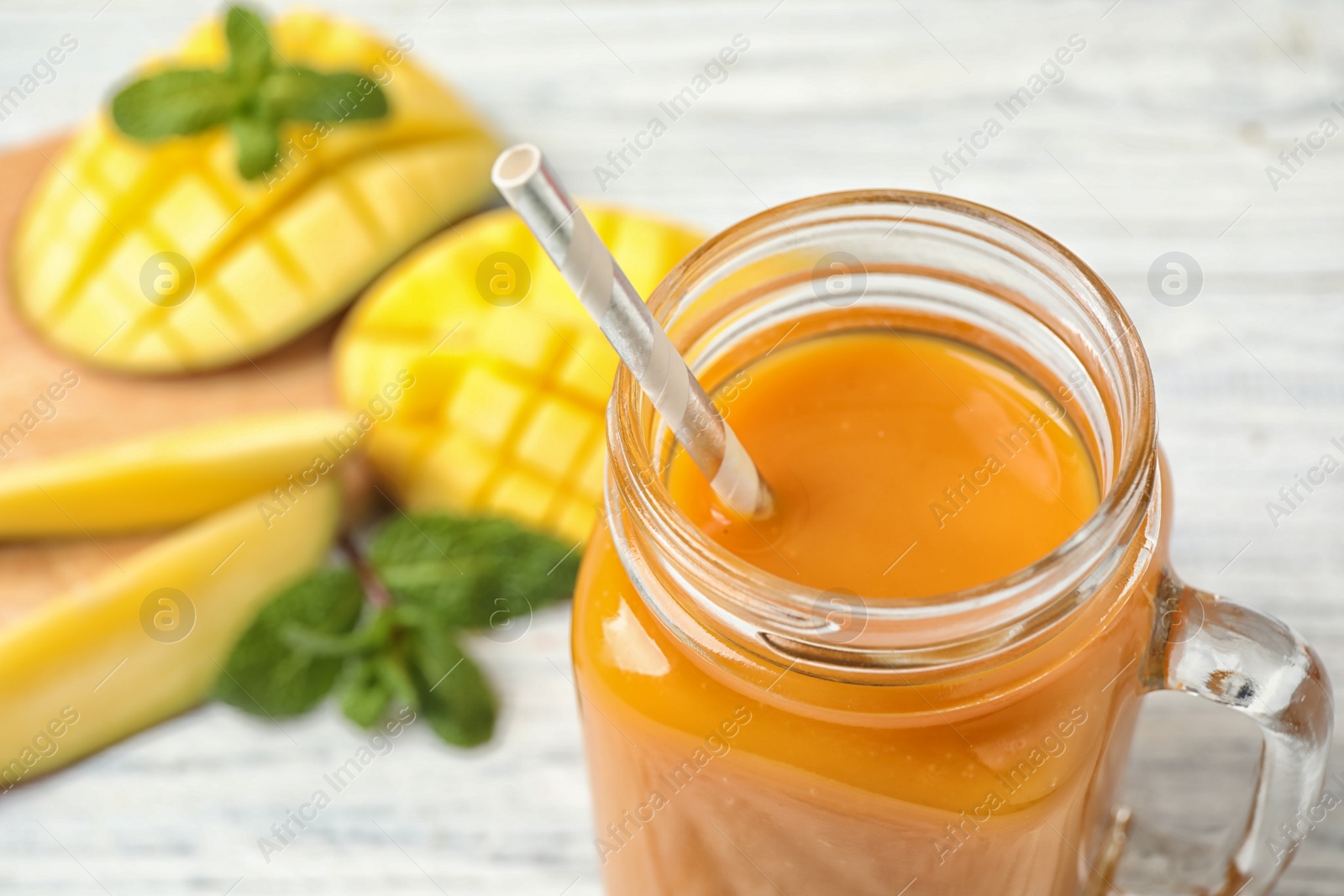 Photo of Fresh delicious mango drink on table, closeup