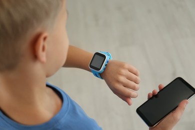 Photo of Boy with stylish smart watch and phone, closeup view