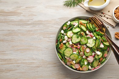 Photo of Delicious cucumber salad served on white wooden table, flat lay. Space for text