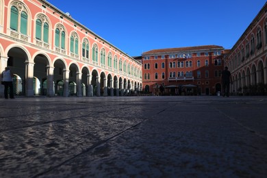 Photo of Beautiful view of city square with vintage building under blue sky