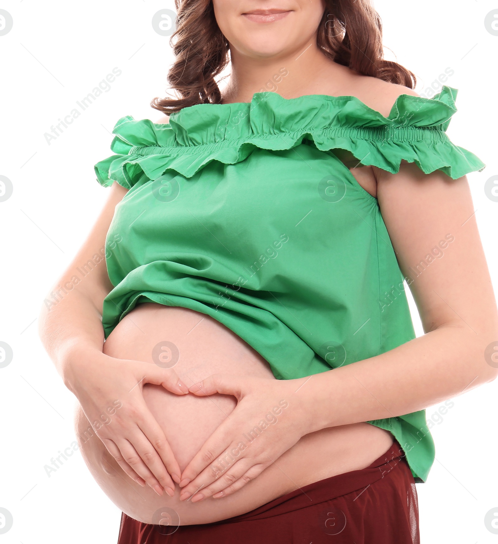 Photo of Young pregnant woman in casual clothes on white background